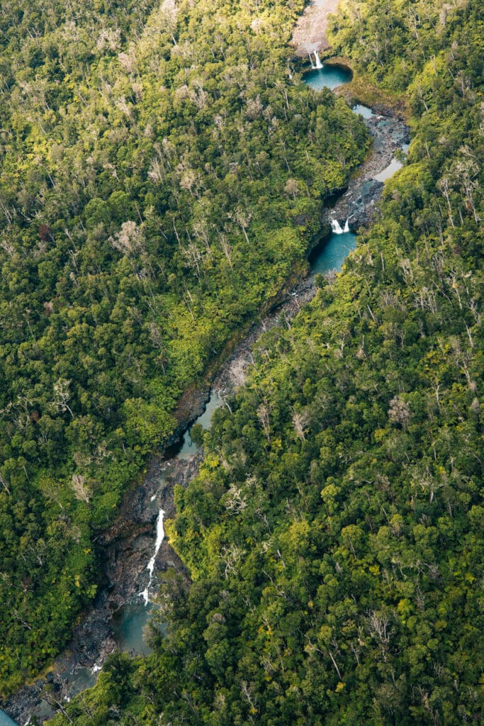 Aerial waterfall in Big Island Hawaii rainforest